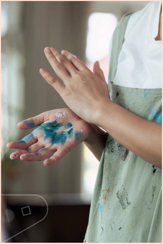 Messy painters hands in paint studio
