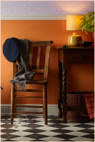 Image of hallway in home with warm apricot cladding below dado rail and lavender wallapper above